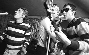 Ca. August/September 1964, at the Railway Hotel, with Epiphone Rivoli bass, and what appears to be a Marshall amplifier in the backline.