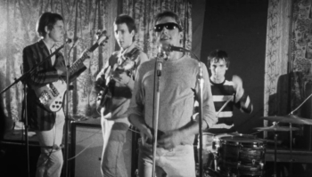 Ca. 1964, at the Railway Hotel, with with Rickenbacker Rose, Morris, Co. LTD, 1999 (4001S) bass and early Marshall 4×12 speaker cabinet.