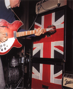 Click to view larger version. Ca. 1965, grinding a 1964 Rickenbacker 360/12 Export into an early “stack” of Marshall 4×12 cabinets powered by a Fender Bassman atop the stack, which is daisy-chained to a custom Fender Pro head at lower right.