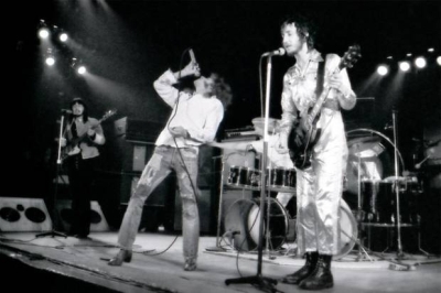 Ca. 1971, closeup view of stage, with eary evidence of the use of a floor wedges visible at stage right. Sunn monitor stack at rear of stage next to John’s Sunn bass rig.