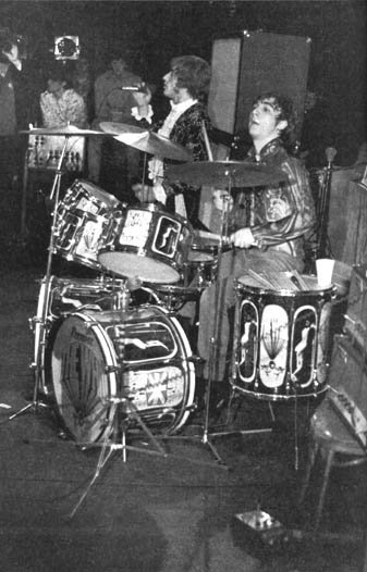 Ca. 1968, two Sunn 100S amplifiers visible at far right. John’s Sunn 2×15 cabinet stacks visible in background. Effects pedal is unknown.