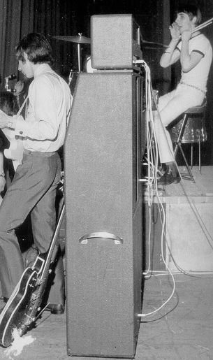 Rear view of the Marshall 8×12 cabinets, with top portion open-back design. The amplifiers are ’65 1959T JTM100 Super Lead Tremolo (top), ’67 1967 Marshall Major Lead (“Pig”), and on the ground, a Marshall JTM45 100 Super PA for vocals.