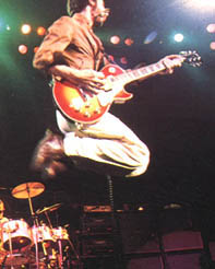 Early ’76, cherry sunburst, hand-numbered three-pickup model, with prototype-era black surround of the middle-position pickup.